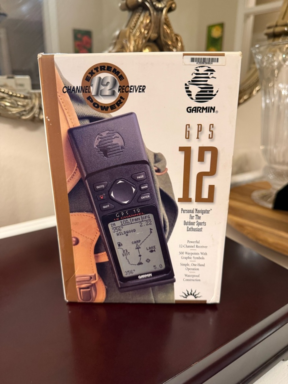 SOLD- garmin handheld GPS unit in black and cream packaging